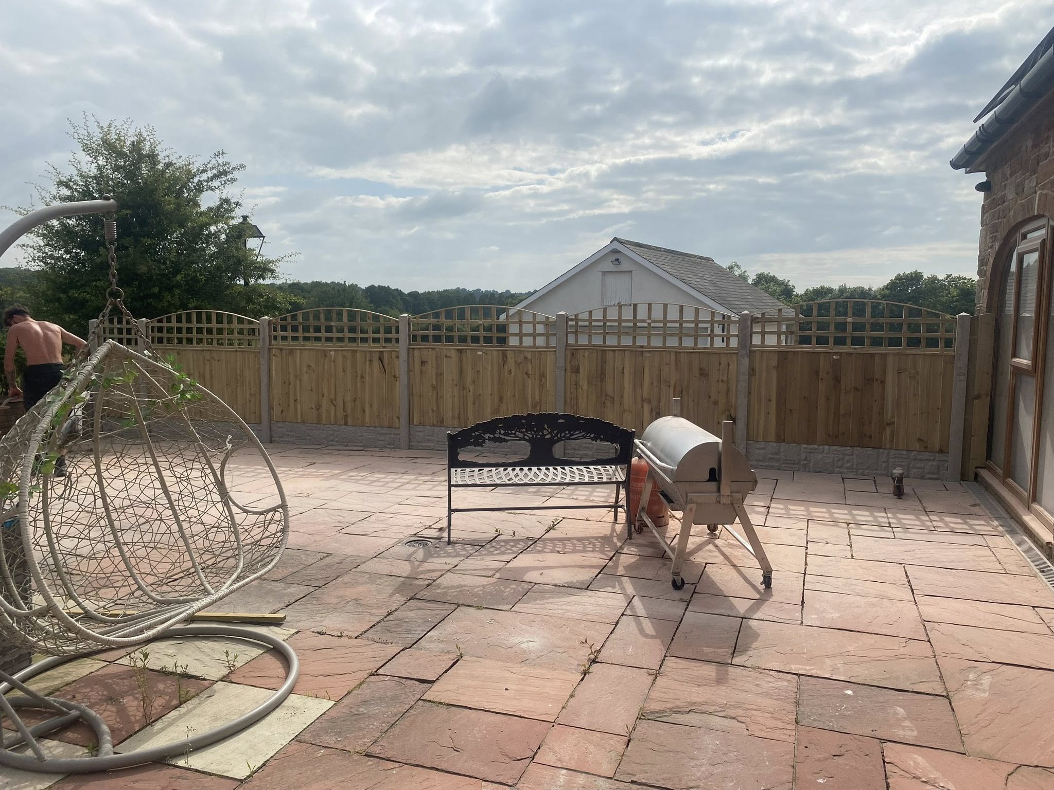 Completed patio with garden furniture and fencing by Nicky Gardner